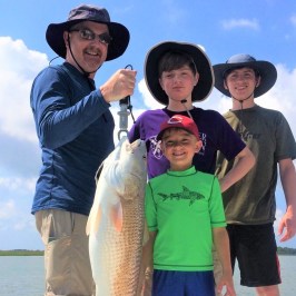 group holding fish they caught